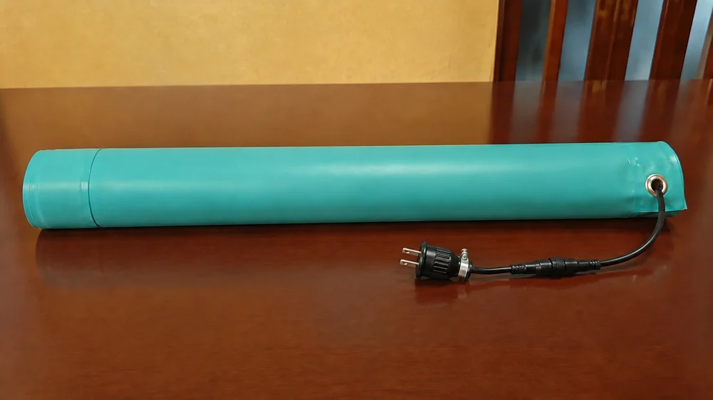 使わない季節に丸めて保管した融雪マットと電源プラグ
